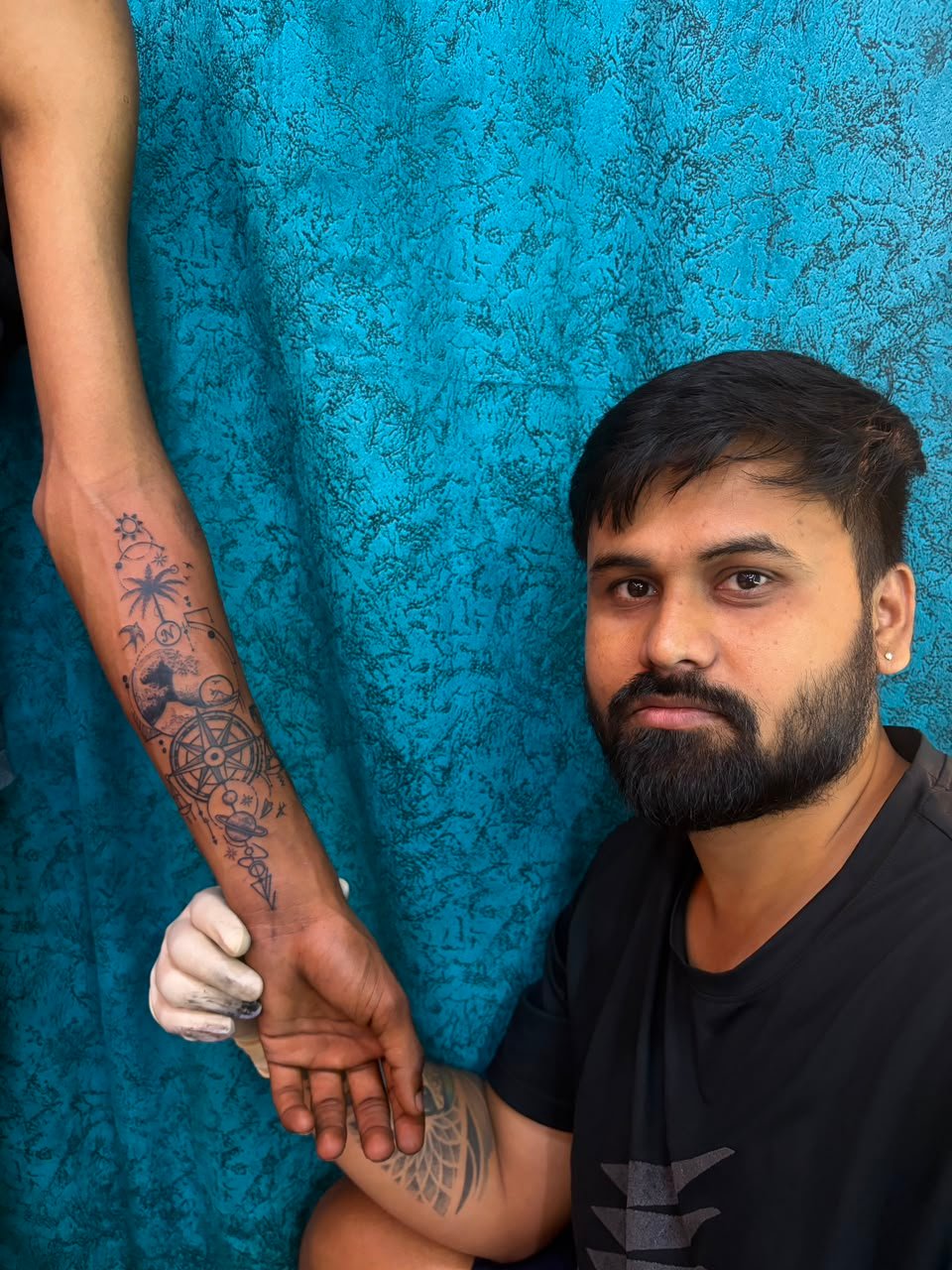 Tattoo artist creating meaningful body art at Tiger Tattoo and Piercing